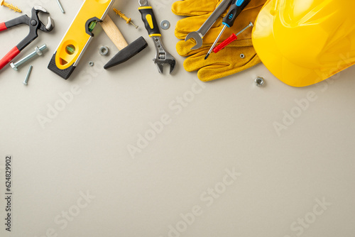 Fotografía Paying homage to construction professionals on Labor Day: overhead composition highlighting construction gear and tools against light grey backdrop