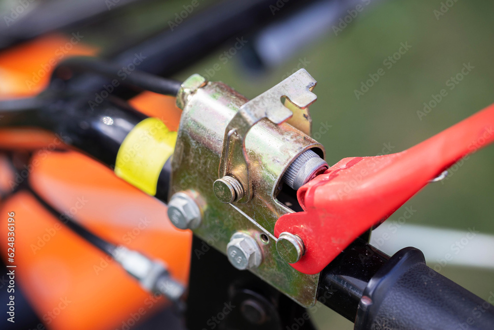 button for safely turning off the engine of the walk-behind tractor, close-up