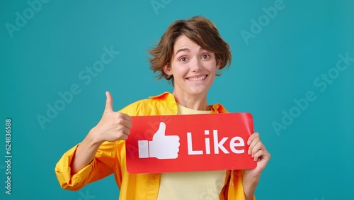 Cheerful woman shows red like button sign and shows thumb-up photo