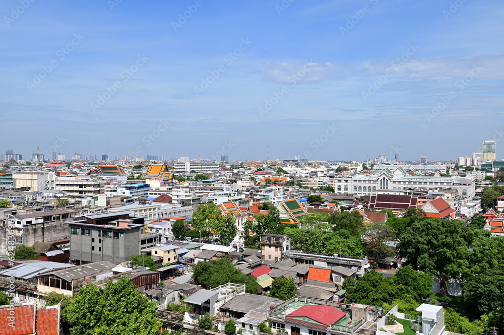 Obraz premium BANGKOK, THAILAND - July 22, 2023 : Landscape View of Bangkok City and Thai Buddhist Temple with Blue sky with white cloud. Clear day and good weather in the morning.