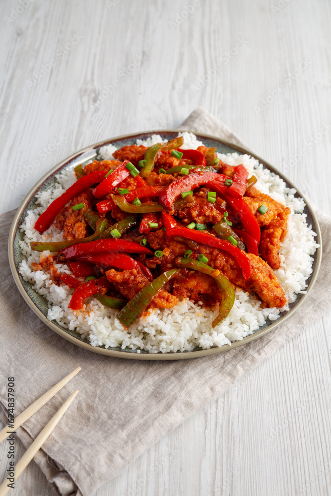 Homemade Simple Chili Chicken with White Rice on a Plate, side view.