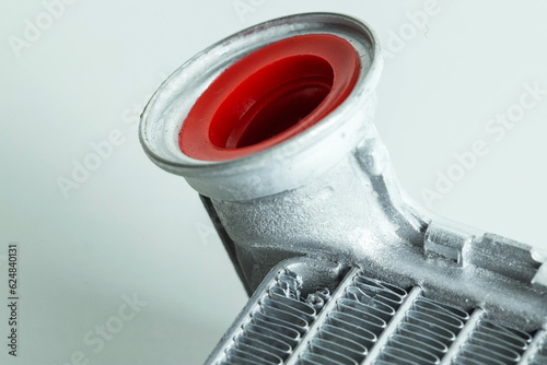 Part of a car heater radiator on a white background, close-up. Automotive spare part. Close-up photo