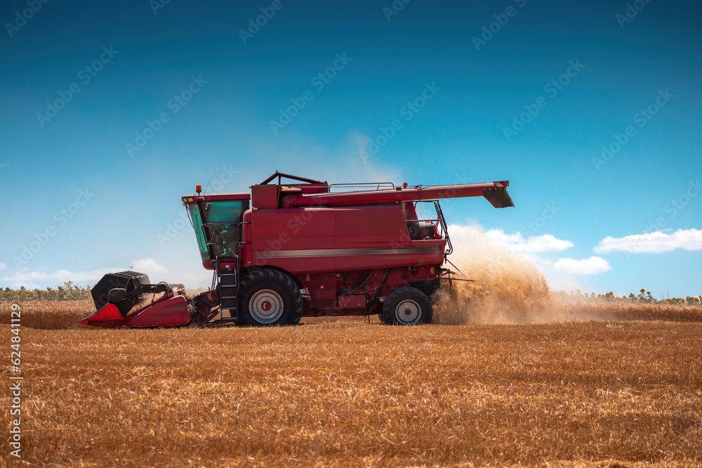 Combine harvester machine working in a wheat field Combine harvester machine working in a wheat field