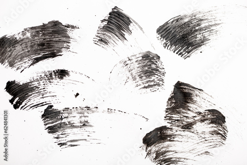Black mascara brush strokes isolated on white.