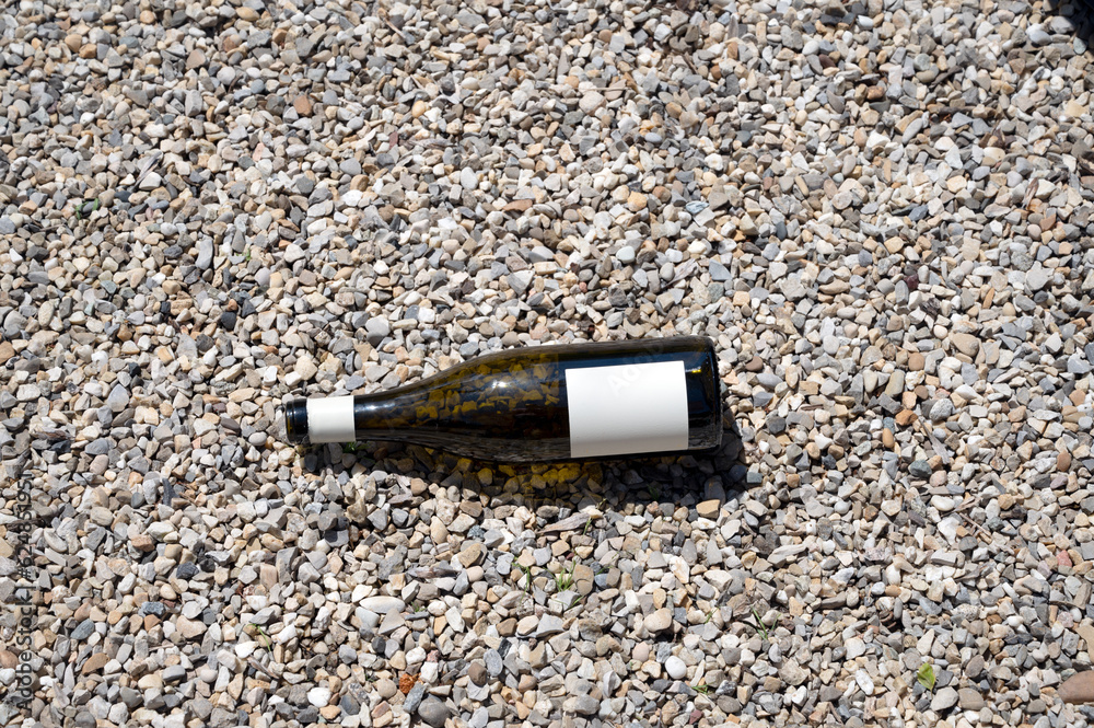 An empty bottle on the gravel An empty bottle on the gravel