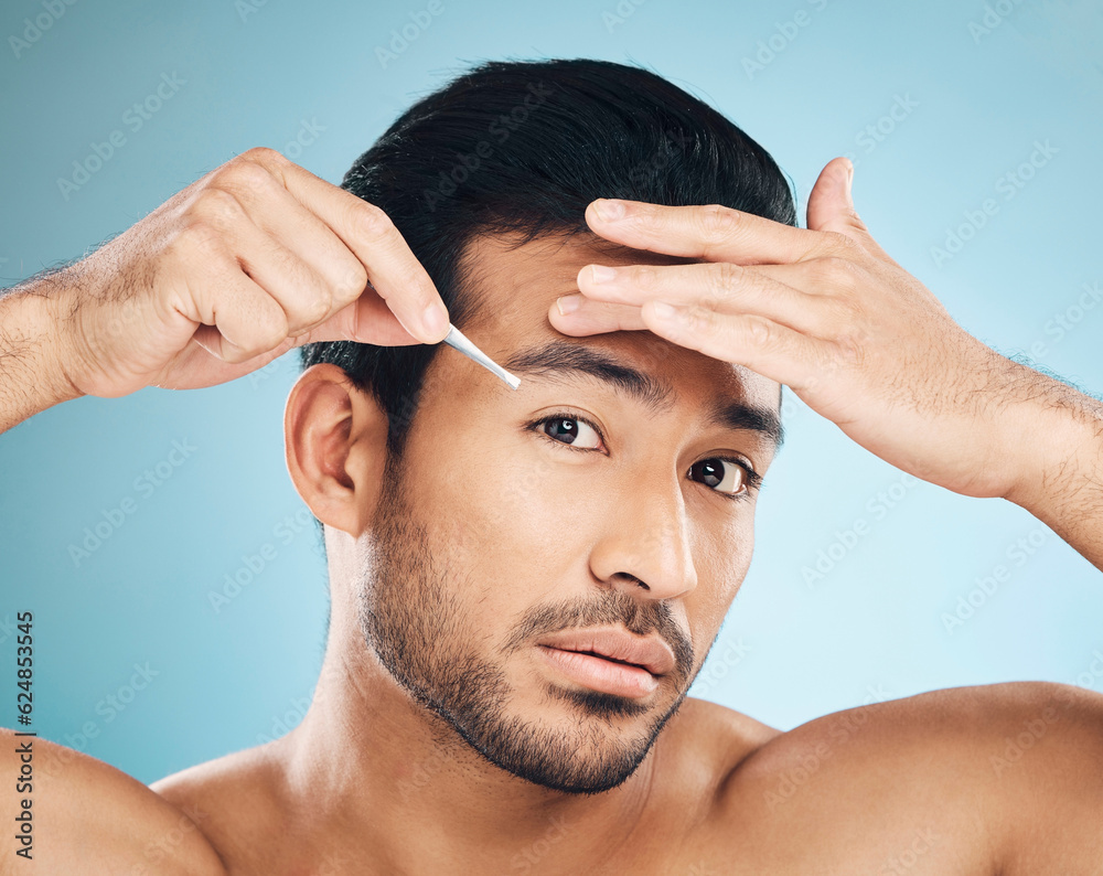Man, face and eyebrow tweezers, beauty and skin, hair removal and cosmetics on blue background. Grooming, hygiene and male model, portrait and wellness with treatment, tools and self care in studio