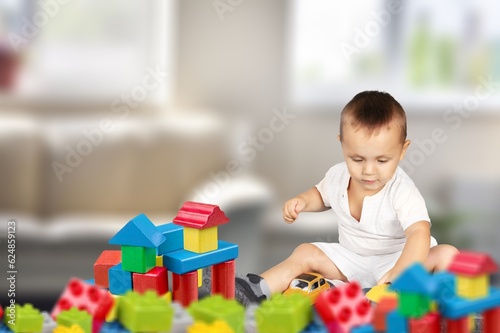 Cute child play with toys in room.