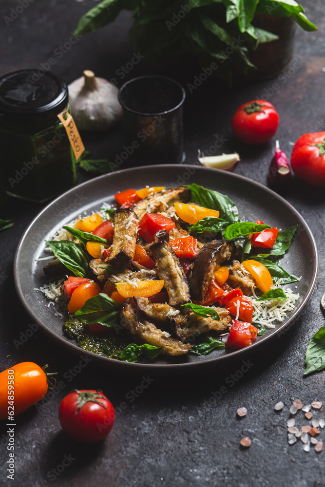 Warm eggplant, pepper, tomato and basil salad