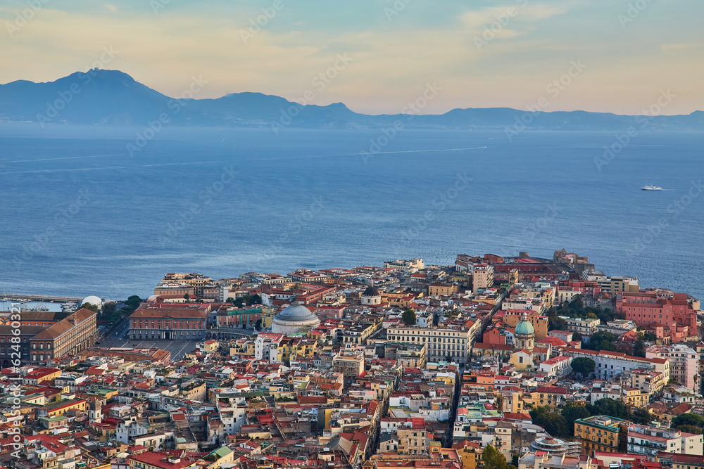 Naples, Italy evening panorama of city center coastal section with Plebiscito square and Palazzo Real