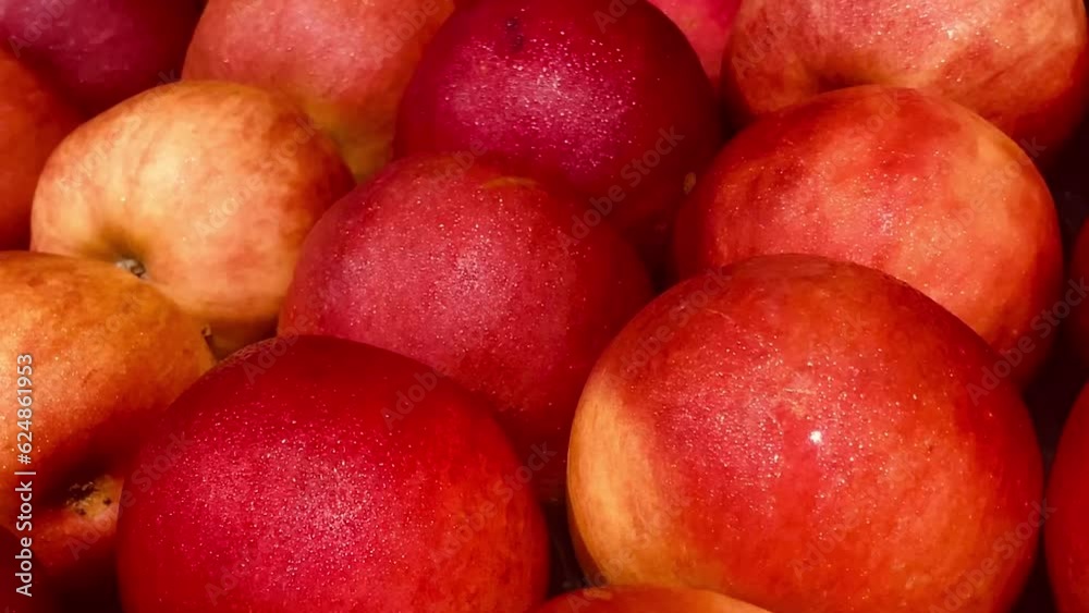 Red, juicy, ripe apples with a slightly yellowish tint are lying on the counter, in a close-up shot Red, juicy, ripe apples with a slightly yellowish tint are lying on the counter, in a close-up shot