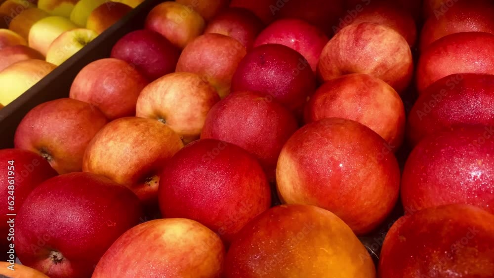 Red, juicy, ripe apples with a slightly yellowish tint are lying on the counter, in a close-up shot Red, juicy, ripe apples with a slightly yellowish tint are lying on the counter, in a close-up shot