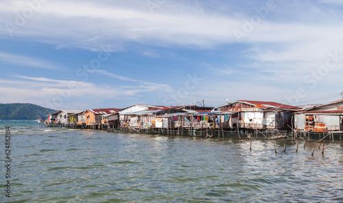 Residential wooden houses and barns on stilts in poor district, Malaysia © evannovostro