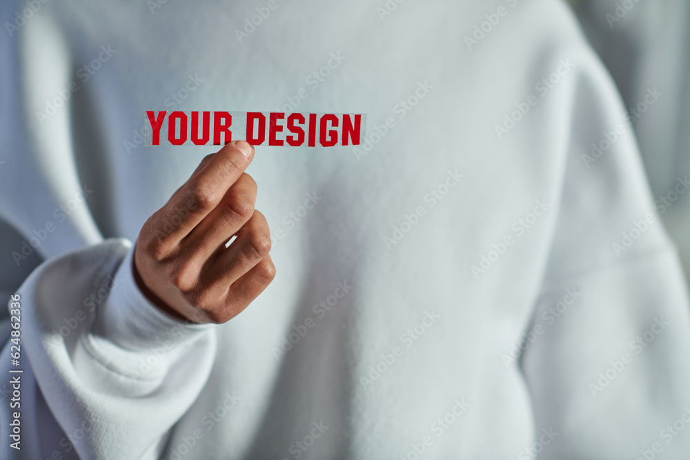 Cropped view of young african american craftswoman in sweatshirt holding printing layer with your design lettering while working in print studio, focused business owner managing workshop Cropped view of young african american craftswoman in sweatshirt holding printing layer with your design lettering while working in print studio, focused business owner managing workshop