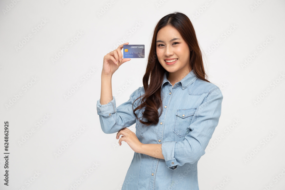 .Young Asian woman smiling, showing, presenting credit card for making payment or paying online isolated on white background .Young Asian woman smiling, showing, presenting credit card for making payment or paying online isolated on white background