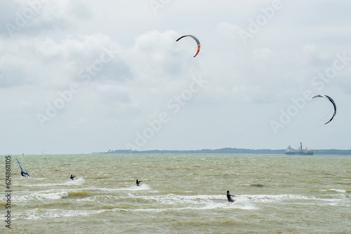 kitesurfers and windsurfers on The Solent in Hampshire England with the Isle of Wight in the background