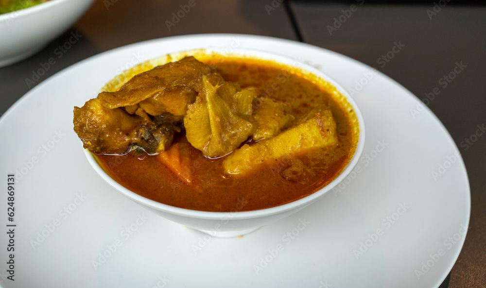 Authentic Thai Curry Chicken - Delectable Thai Style Food on White Background Authentic Thai Curry Chicken - Delectable Thai Style Food on White Background