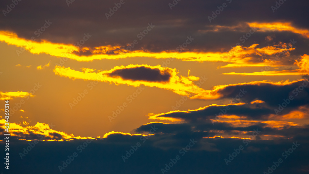Obraz premium the expressive contrast of the clouds in the sky. sunset with bright clouds