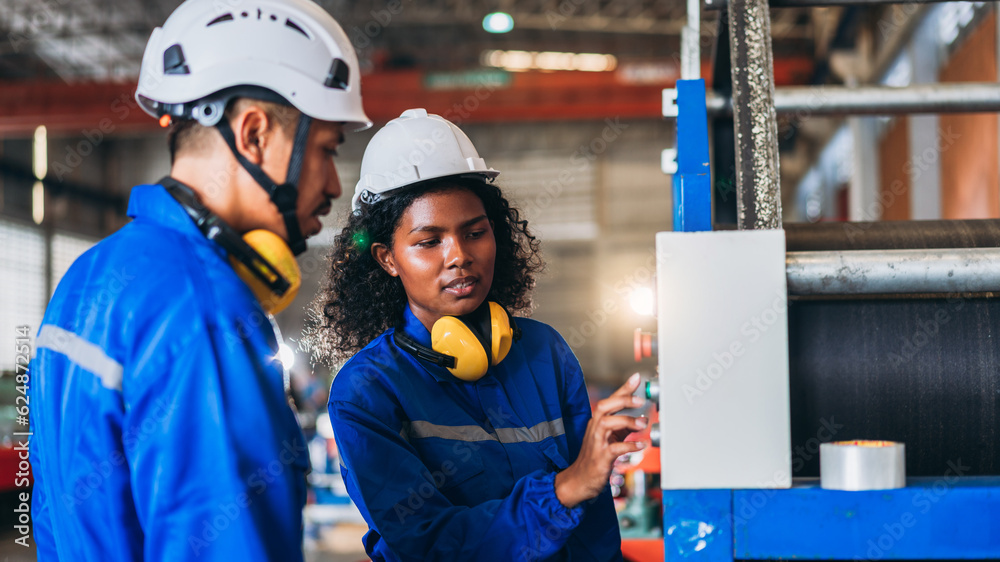 Industrial worker inspecting and check up machine at factory machines. Technician working in metal sheet at industry. Foreman checking Material or Machine. Industrial worker inspecting and check up machine at factory machines. Technician working in metal sheet at industry. Foreman checking Material or Machine.