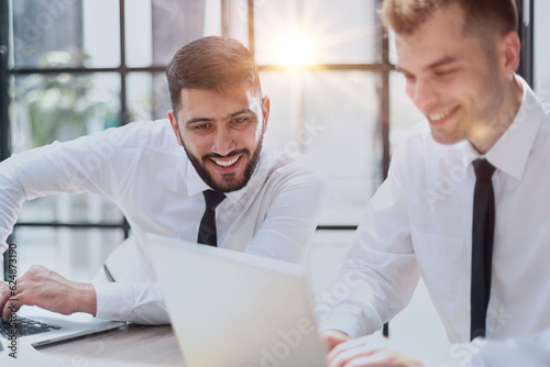 Two happy men working together on a new business project