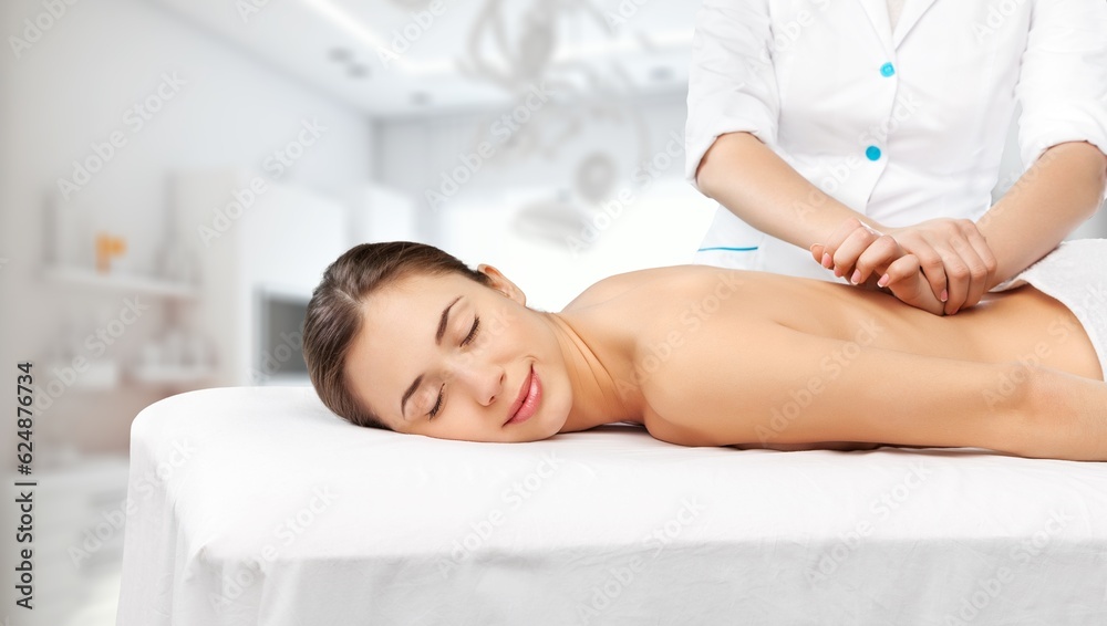 Beautiful young Woman Enjoying Massage In Salon Beautiful young Woman Enjoying Massage In Salon