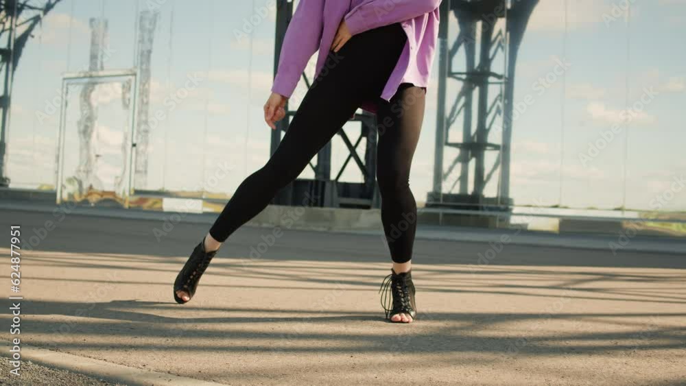 Young woman dancing hip hop elegant dance on high heels. Modern Jazz Funk dance choreography. Female professional dancer showing dance movings. Musical video. Young woman dancing hip hop elegant dance on high heels. Modern Jazz Funk dance choreography. Female professional dancer showing dance movings. Musical video.