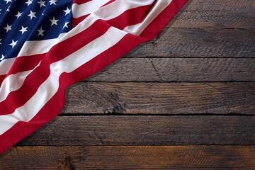 Top view overhead America United States flag, memorial remembrance and thank you of hero, studio shot with copy space on wooden table background, USA holiday Veterans or Independence day concept.