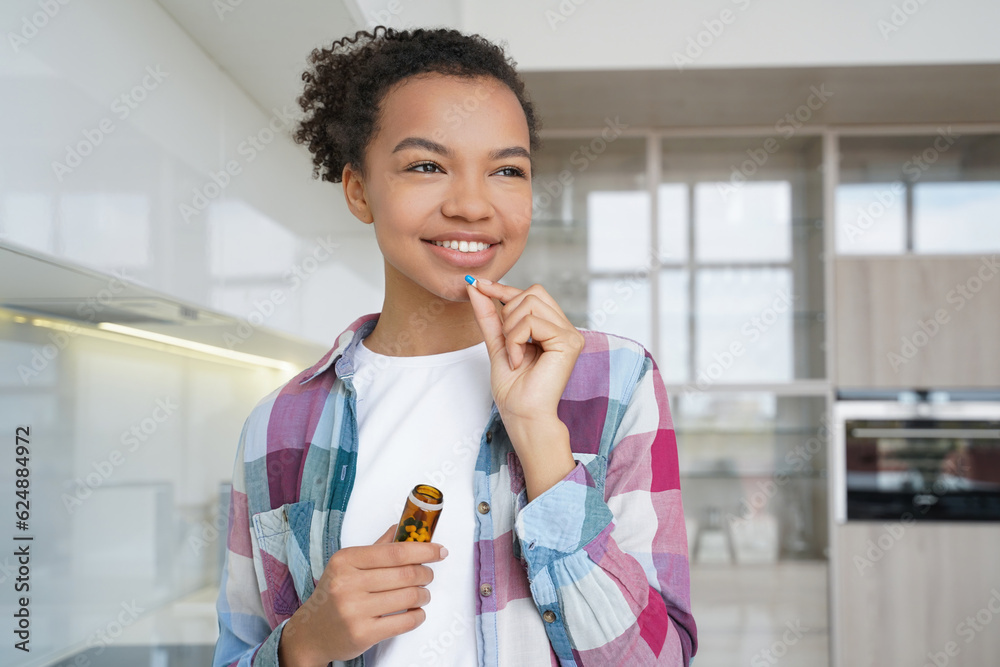 Happy girl takes pills for wellness, promoting healthy lifestyle at home. Happy girl takes pills for wellness, promoting healthy lifestyle at home.