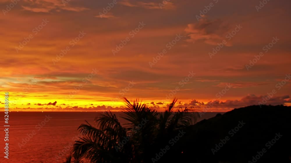 beautiful red clouds are moving slowly in the colorful sky at sunset..Nature video High quality footage. Meditation ocean and sky background..Majestic sunset or sunrise cloud scape background.
