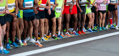 Legs of multi-ethnic athletes before marathon start