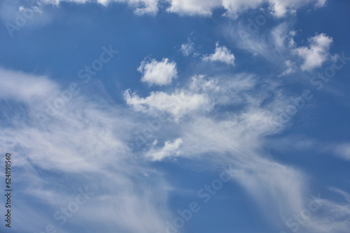 Fototapeta Naklejka Na Ścianę i Meble -  Cloudy blue sky background with white swirling clouds.