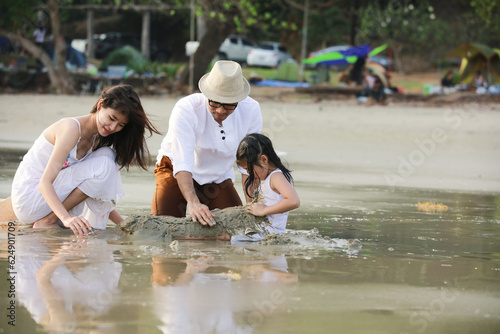 Happy Family on Summer Vacation at Beach