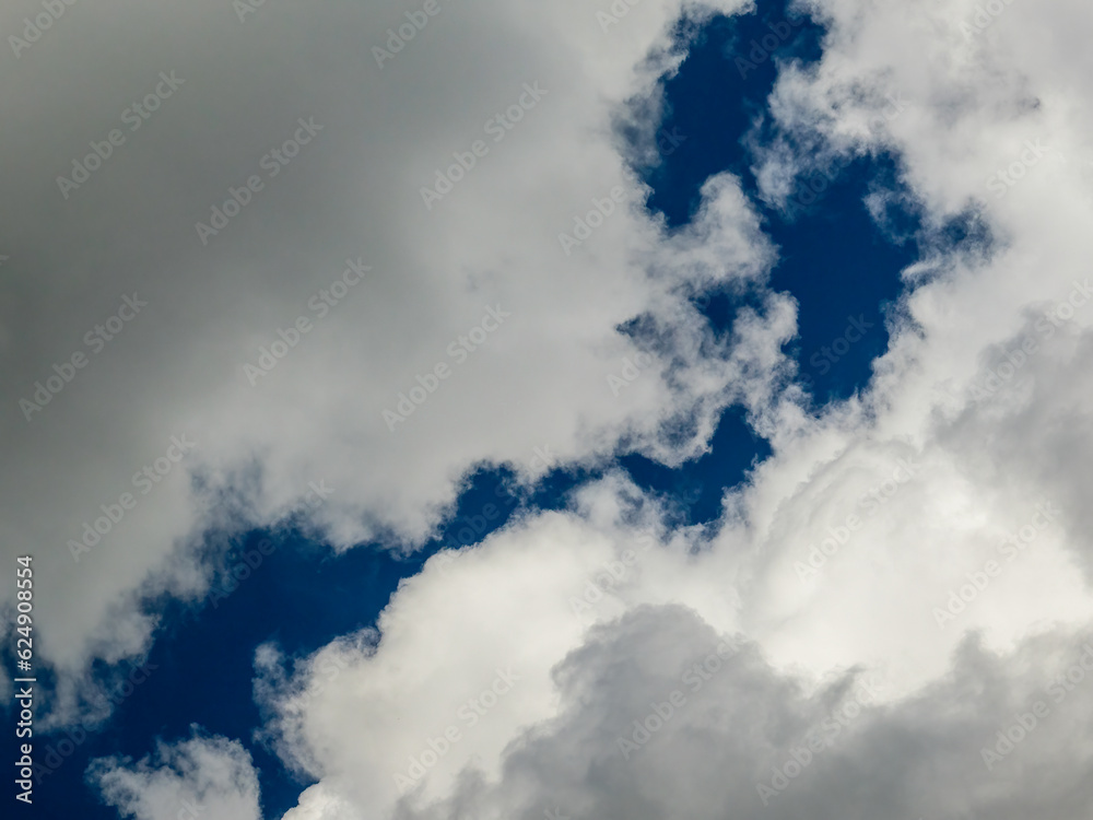 Ragged rift in shifting cumulus clouds at the edge of an approaching storm front on a spring afternoon in southwest Florida. For motifs of schism, instability and flux. Ragged rift in shifting cumulus clouds at the edge of an approaching storm front on a spring afternoon in southwest Florida. For motifs of schism, instability and flux.