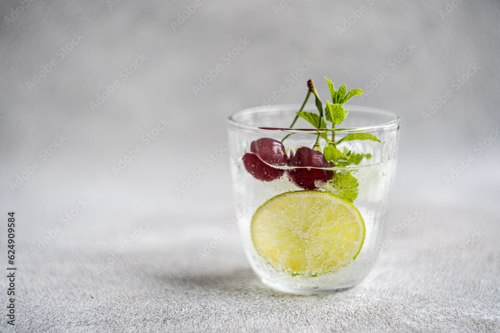 Glass of fresh lime mint and cherry Glass of fresh lime mint and cherry