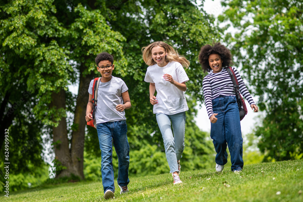 Group of young people feeling excited and happy in the park Group of young people feeling excited and happy in the park