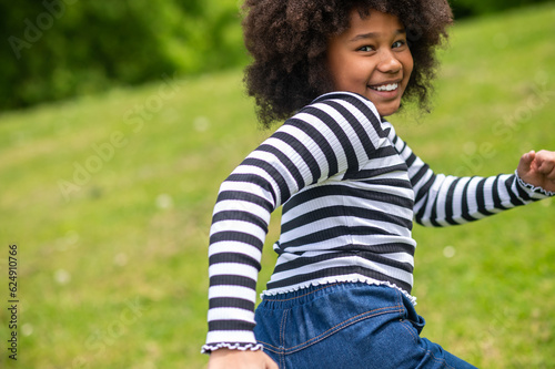 Curly-haired cute kid running and feeling excited