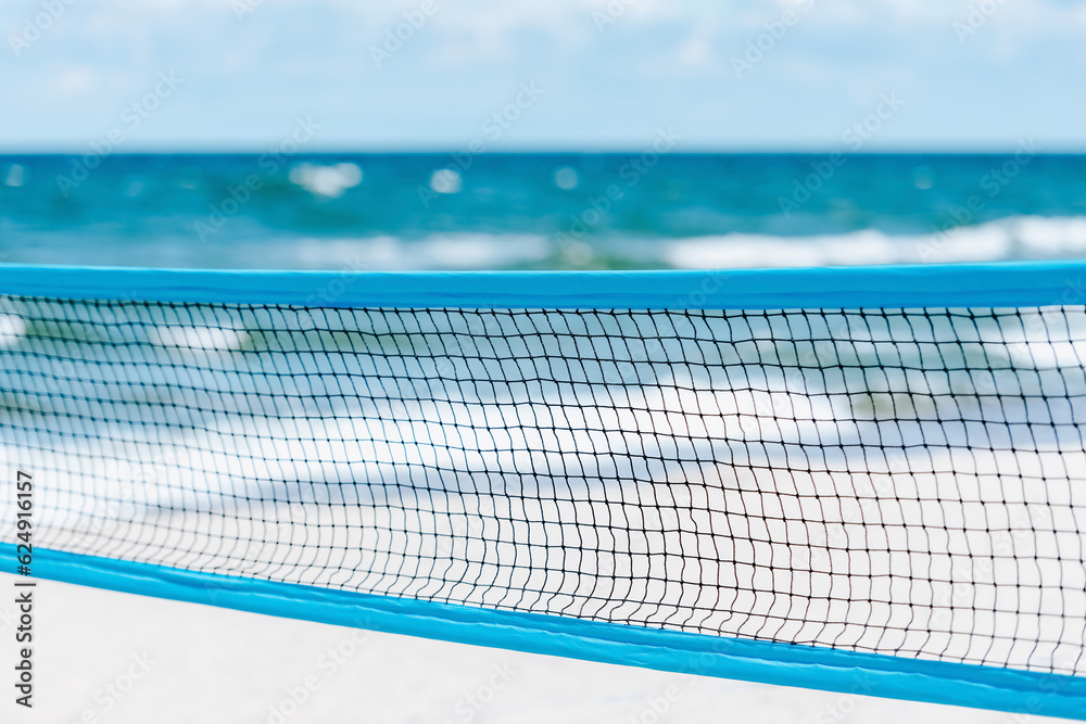 Beach volleyball and beach tennis net on the background of sand