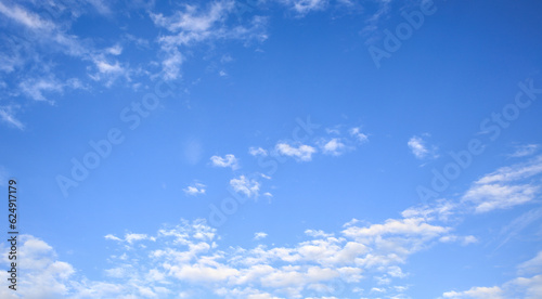 Look up on the blue sky and white clouds background.