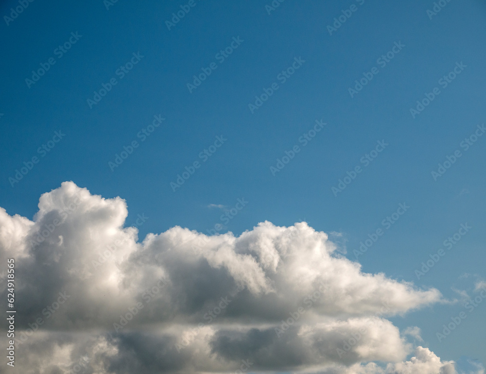 Fototapeta premium White and grey cumulus clouds background over the blue summer sky background