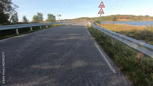 Narrow, traffic-free road, sea left and right, summer, Kystriksveien, RV 17, Heroey, Helgeland, Norway, Europe photo