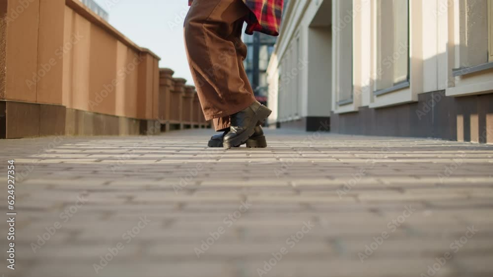 Young woman dancing hip hop elegant dance on high heels. Redhead curly girl dance Modern Jazz Funk choreography. Female professional dancer showing dance movings. Musical video.