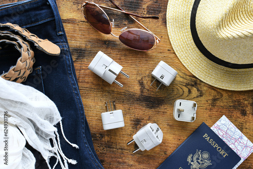 Foto Travel essentials flat lay including power converter, voltage travel adapter 220