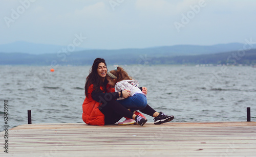 Woman and Kid Having Fun on a Lake Background .Family Portrait in the Nature 