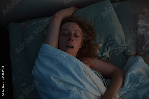 Canvastavla Young beautiful woman sleeping in bed at early morning