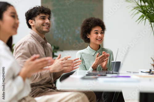 Colleagues Expressing Joy Over Business Achievement With Applause in Office