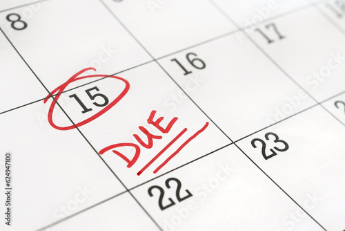 Calendar with the 15th of the month circled and word DUE written on it