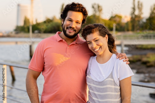 Happy caucasian adult couple hugging, rest, enjoy walk and date on sea pier, close up