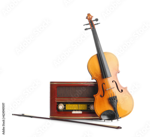 Violin and retro radio receiver on white background