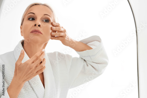 Mature woman doing face bui...