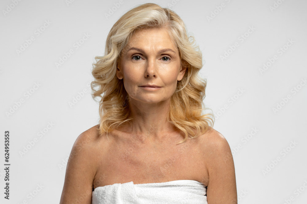 Beautiful confident blonde Caucasian 50-55 years mature woman looking at camera Beautiful confident blonde Caucasian 50-55 years mature woman looking at camera