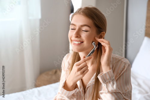 Young woman with facial mas...
